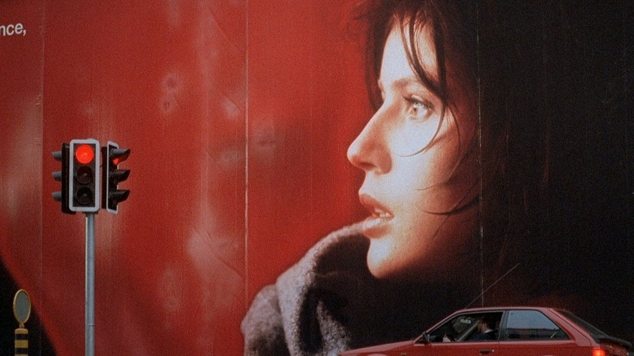 still from The Day of the Jackal (1973) - a billboard of a beautiful woman looking to the left against a red background